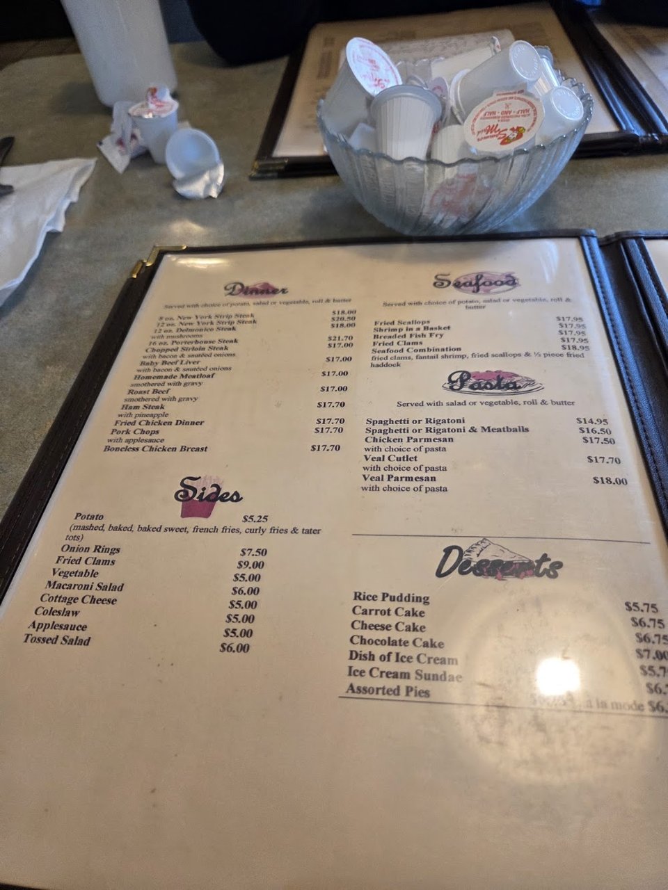 Menu page listing steaks, seafood, and pasta.
