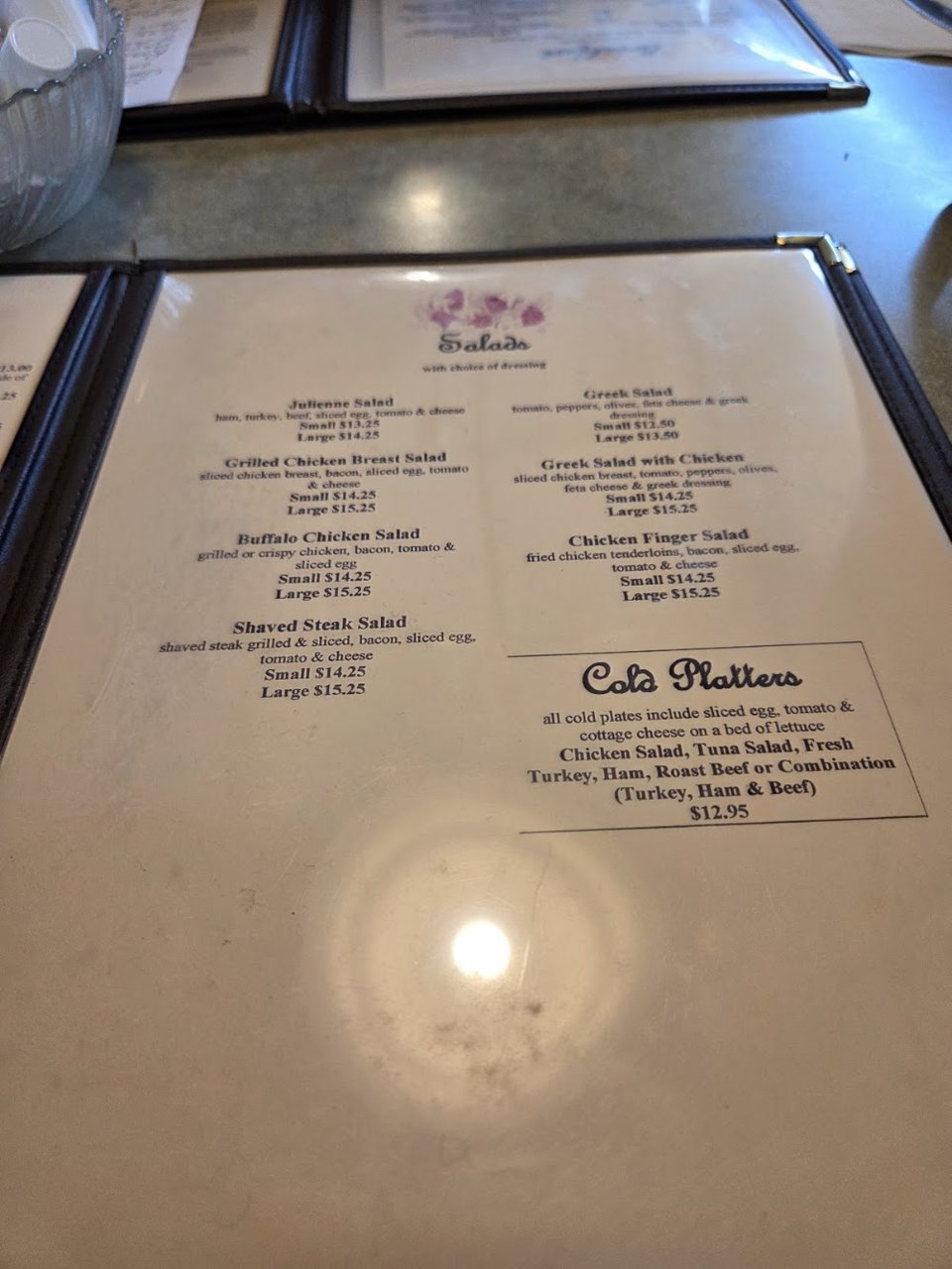 Close-up of a diner menu with many choices.